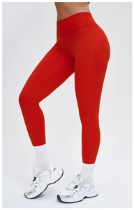 Side view of high-waisted red yoga pants showing moisture-wicking fabric and slim fit