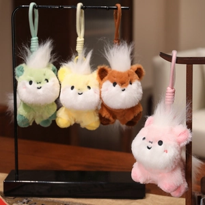 Set of four colorful plush pony keychains in pink, yellow, and green candy colors