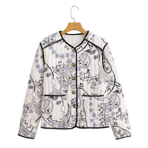 Quilted cotton jacket with vintage paisley print, black piping, and front pockets on white background