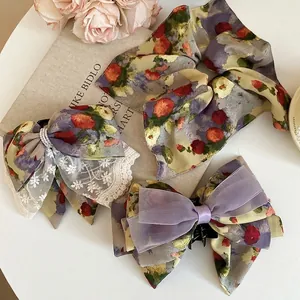 Floral bow hair clip and scrunchie set with white lace trim and organza detailing