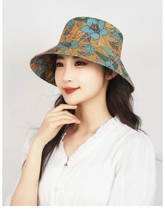 Detail of floral ginger sun hat with blue tropical print and wide brim for sun protection