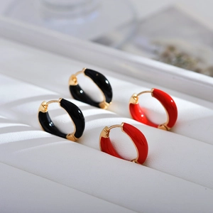 Geometric enamel hoop earrings in black and red with gold accents for a minimalist look