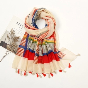 Detailed view of geometric striped cotton scarf with colorful patchwork and fringe tassels