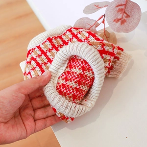 Detail of soft knit pet sweater featuring multi-color bear pattern and ribbed collar