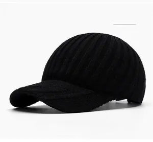 Detailed close-up of a black ribbed knit baseball cap showcasing thick yarn texture