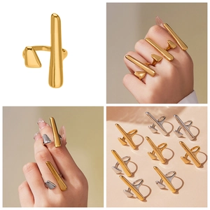 Detail showing minimalist gold and silver geometric open rings on model's hand