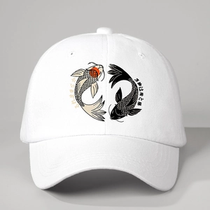 Close-up of white baseball cap featuring koi fish yin yang embroidery and twill texture