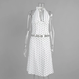 Detailed view of polka dot print texture and fabric on halter top and midi skirt set