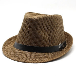 Detail of woven straw fedora featuring a black leather band and silver metal buckle
