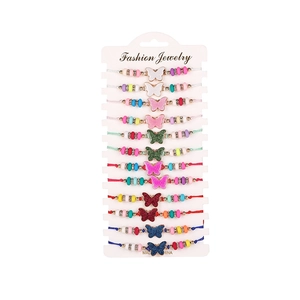 Detailed close-up of 12 multi-color woven butterfly charm bracelets on display cards