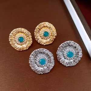 Detail of vintage sunflower earrings with turquoise stone and white zircon in 2x2 grid