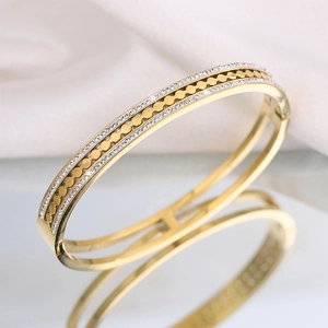 Detailed macro view of the gold plated starburst bangle with white zircon inlays