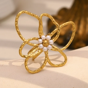 Detailed close-up of 18K gold plated flower ring with hammered texture and pearl center