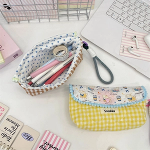 Close-up of cute cartoon puppy print on a quilted fabric stationery pouch with mesh pocket