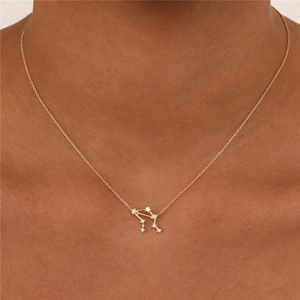 Detail of Libra zodiac constellation pendant with sparkling cubic zirconia on gold chain