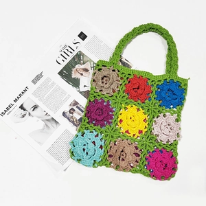 Detail of handmade green crochet tote bag with colorful floral patchwork patterns