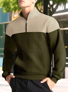 Detail of olive and apricot hooded sweatshirt with half-zip collar and quilted texture