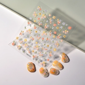 Floral relief nail stickers with orange and white daisy patterns for elegant nail art