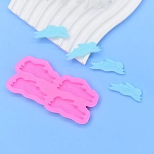 Pink 4-cavity rabbit silicone mold for DIY chocolate and resin crafts with blue rabbit models