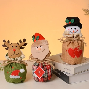 Three-piece burlap Christmas gift bags with Santa, reindeer and snowman designs
