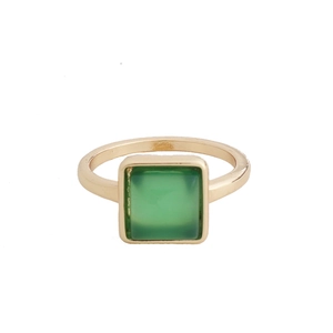Detailed view of a gold square ring featuring a translucent green emerald-style gemstone