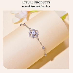 Detailed view of s925 silver moissanite bracelet with flower charm and inlaid diamonds