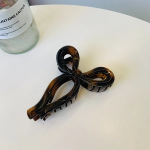 Detail of tortoise shell butterfly hair claw clip with elegant glossy resin finish