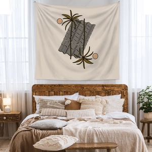 Detail of bohemian tapestry featuring abstract palm tree and waves on a beige wall background