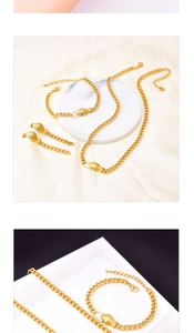 Detail of gold snake-shaped jewelry set with green gemstone eyes on silk and marble base