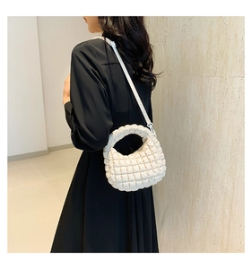 Detailed view of a white quilted nylon crossbody bag with chic checkered stitch patterns