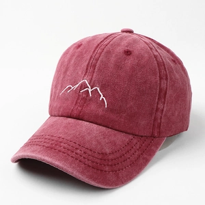 Detailed view of mountain embroidery on a washed burgundy vintage cotton baseball cap