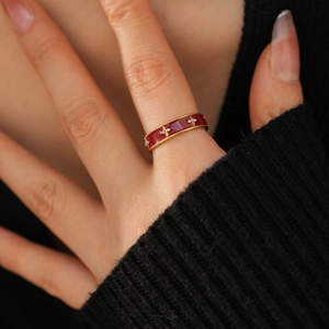 Close-up of 18k gold-plated floral ring with red enamel and white zircon on hand