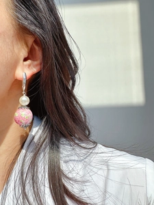 Detail of silver drop earring with white pearl and green pink mottled glass bead