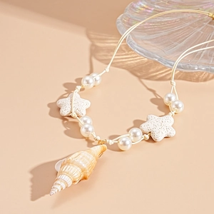 Bohemian pearl necklace featuring starfish and natural conch shell on a beige wax cord