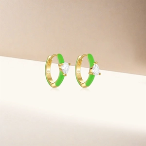 Close-up of S925 sterling silver gold earring with green enamel and drop-shaped zircon
