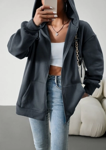 Detail of dark grey hooded sweatshirt fabric with soft texture and front pockets