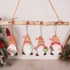 Set of four wooden Christmas gnome ornaments with hanging ropes on a tree branch