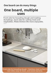 Detailed view of the L-shaped edge on a large stainless steel double-sided kneading board