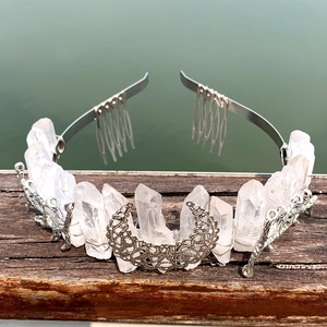 Natural crystal rainbow crown with crescent moon on wood railing over water