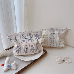 Detail of floral and lace cotton makeup bags with simple wish labels in a dish