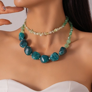 Detail of double-layer necklace with blue marbled resin beads and small natural stones