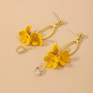 Detail view of sweet yellow flower drop earrings with sparkling round crystals