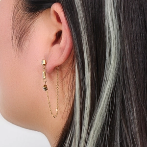 Chic gold chain earrings with triple zircon studs shown on a model for a modern look