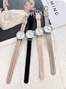 Close-up of stylish nylon strap quartz watches in various colors on knit fabric