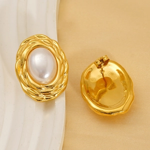 Elegant gold oval pearl stud earrings with vintage braided texture on silk background