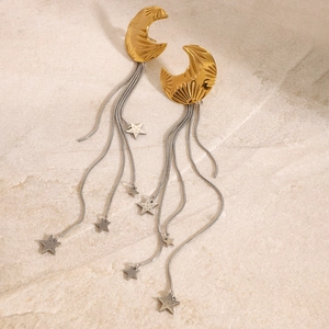 Detail of 18k gold moon stud earrings with long silver tassel and star pendants