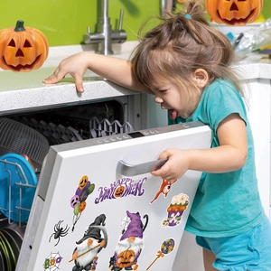 Halloween gnome magnets on a dishwasher door being opened by a child in a festive kitchen