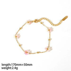 Macro view of 18K gold-plated stainless steel bracelet with colorful flower bead details