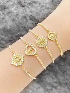 Detail of four gold-plated religious bracelets with Virgin Mary pendants and zircon