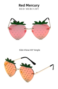 Close-up of strawberry-shaped rimless sunglasses with red gradient lenses and gold frames